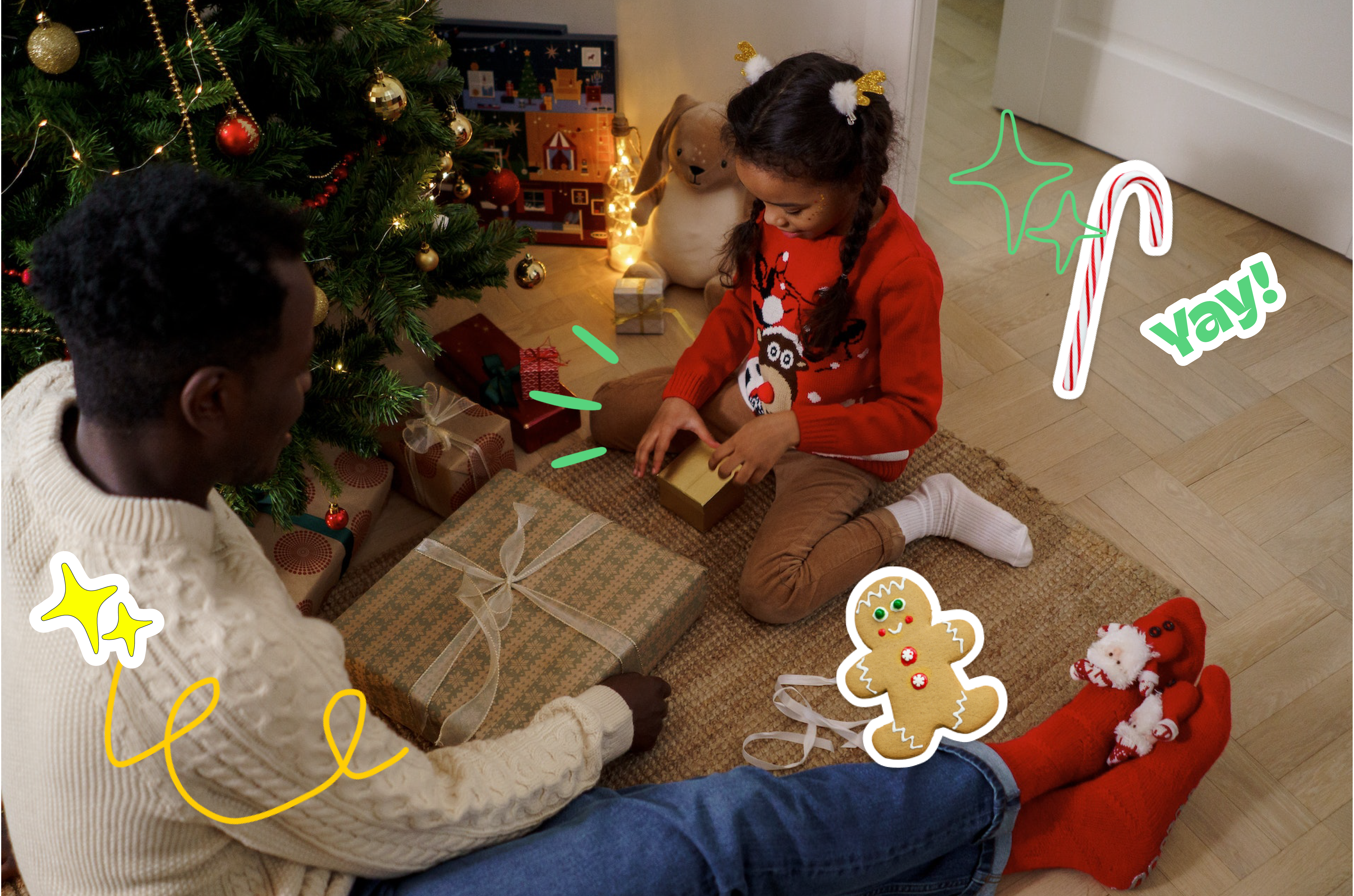 Father and daughter sitting next to a Christmas tree opening presents